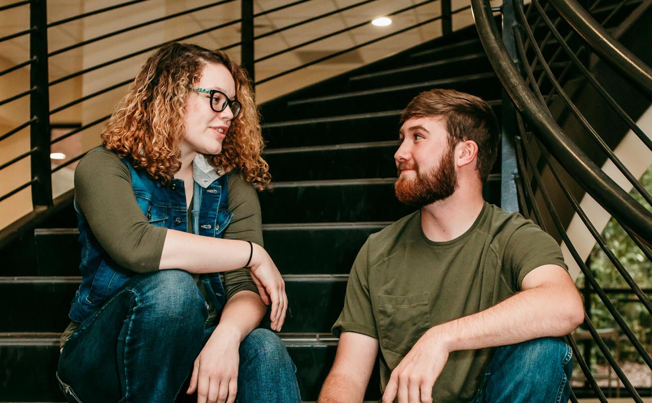 Photo of students talking on a staircase